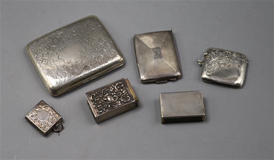 A silver cigarette case, a silver stamp holder, silver vesta case, two match sleeves and one other silver case.